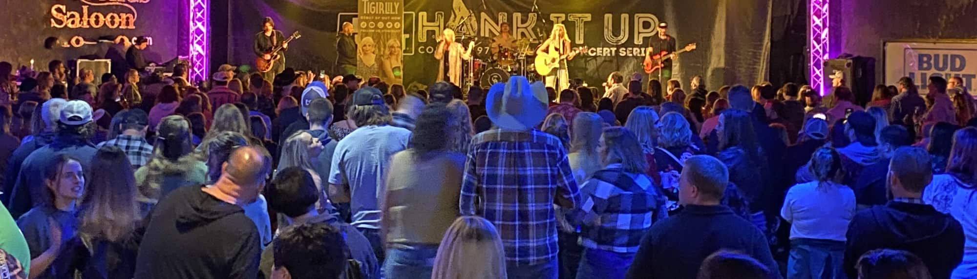 country concert with fans wearing cowboy hats Stockton